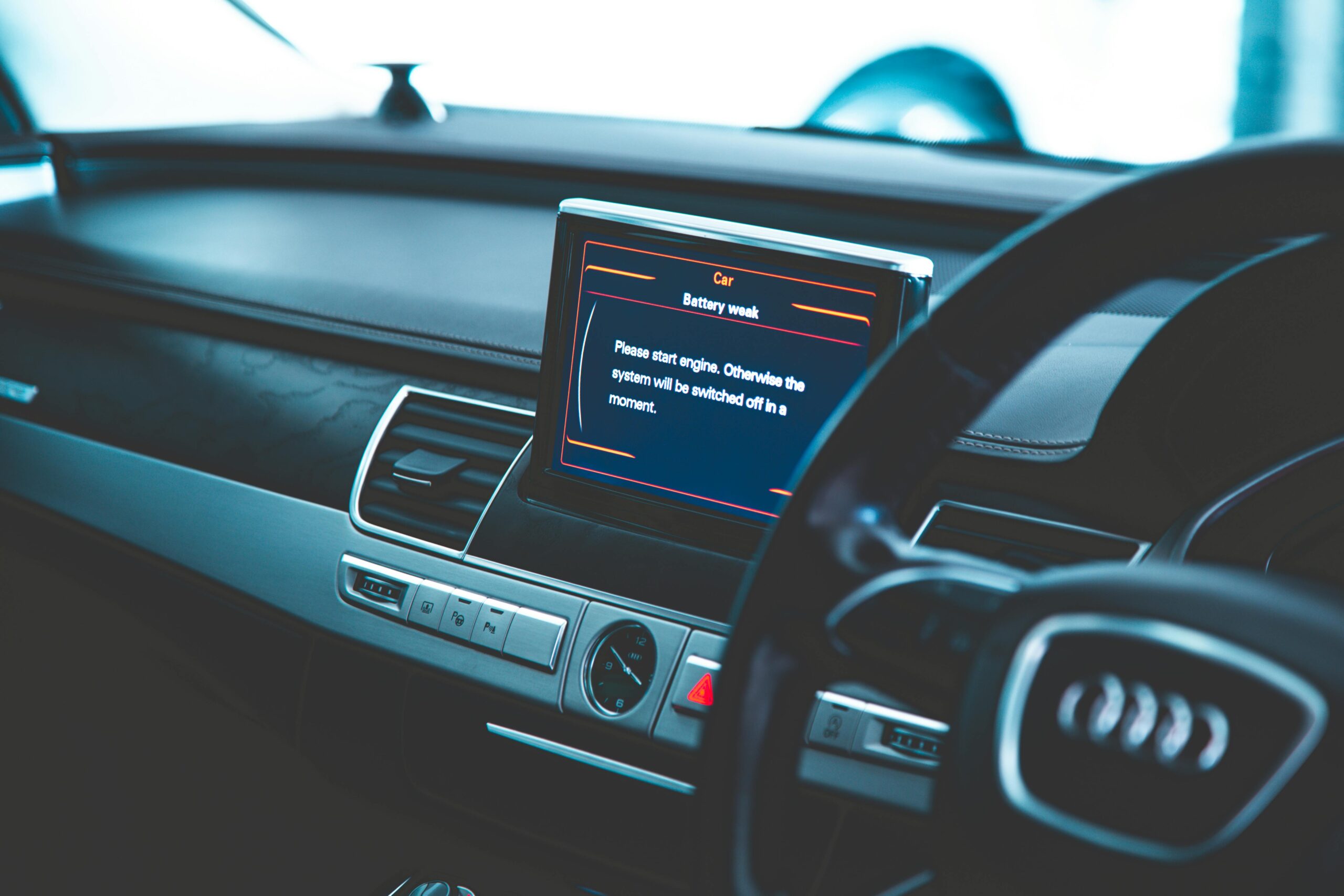 Close-up of a luxury car's interior, showcasing the dashboard and electronic display.