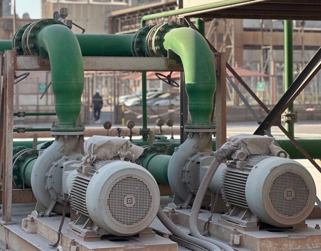 Close-up of industrial pumps at a Dubai power plant, showcasing engineering and industry.